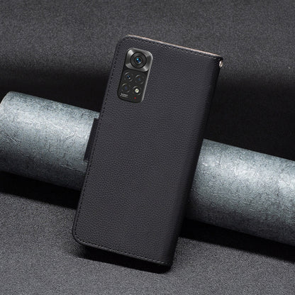 Black textured leather folio phone case with cover strap and camera opening.