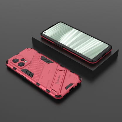 Light red rugged phone case laid flat showing kickstand and textured grip design