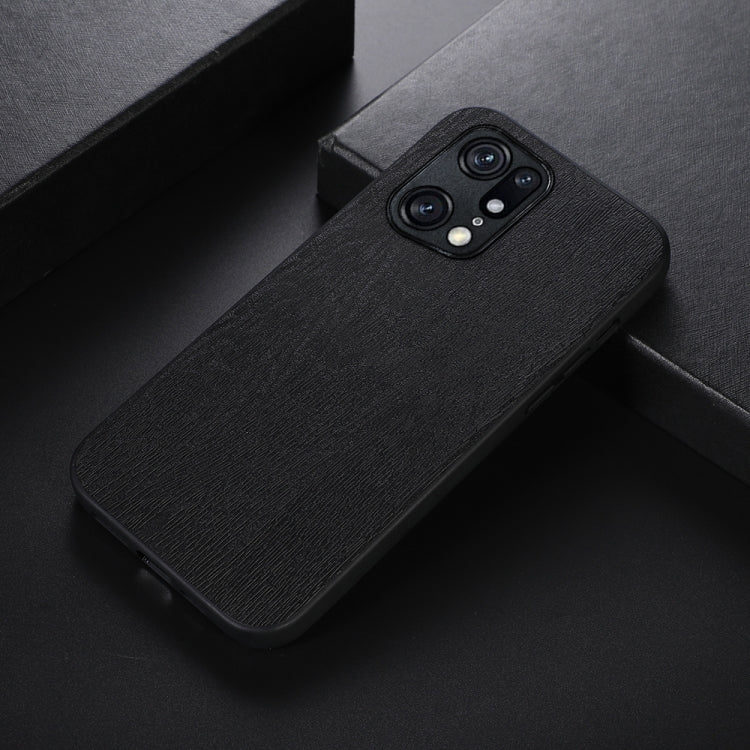 Black wood-texture PU phone case lying on its side, showing dual camera cutouts