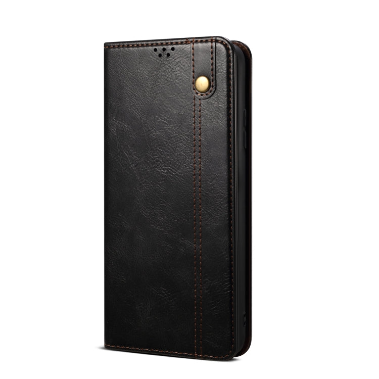 Black leather-look folio phone case with gold snap button and stitched vertical seam.