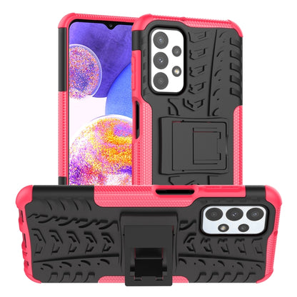 Pink and black shockproof phone case with textured grip, camera cutouts, and holder stand