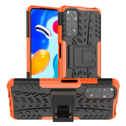 Orange and black shockproof phone case with textured grip, camera cutouts, and holder stand