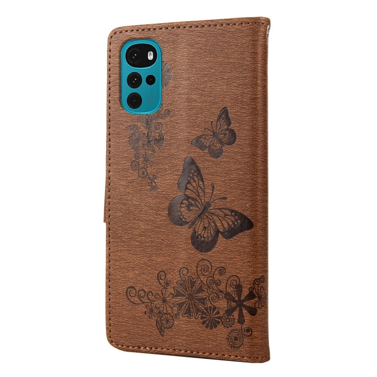 Brown butterfly embossed leather flip phone case with phone back visible