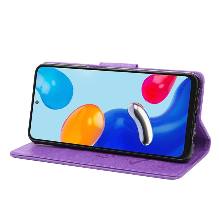 Purple flip leather phone case with butterfly embossing, phone propped in landscape