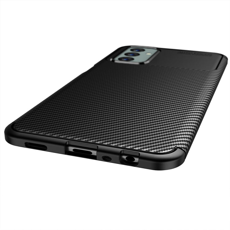 Black TPU phone case with carbon fiber texture and port cutouts along the bottom