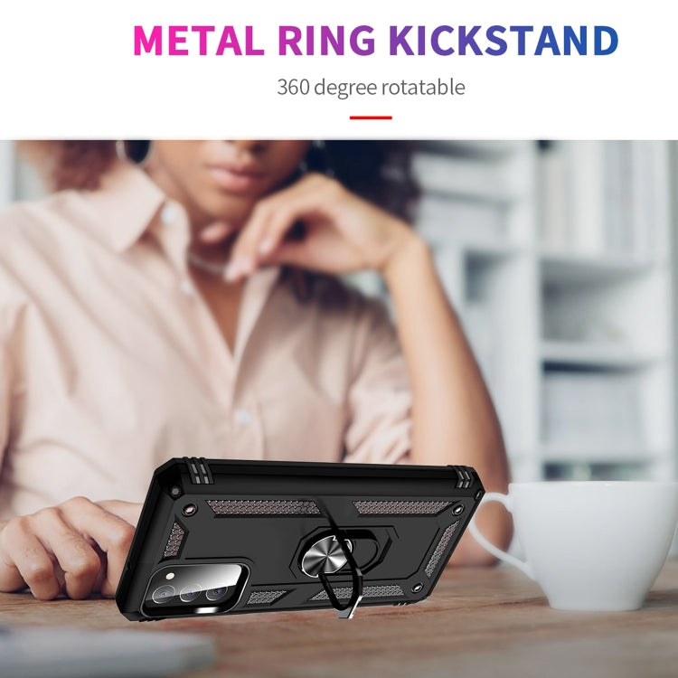 Black rugged phone case with metal ring kickstand on a desk