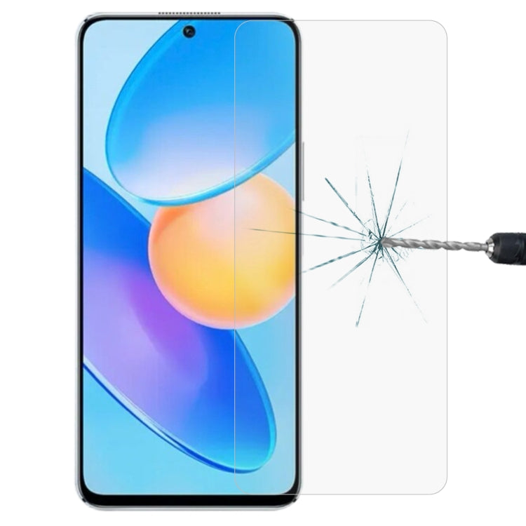 Tempered glass screen protector film on smartphone display with crack test impact.