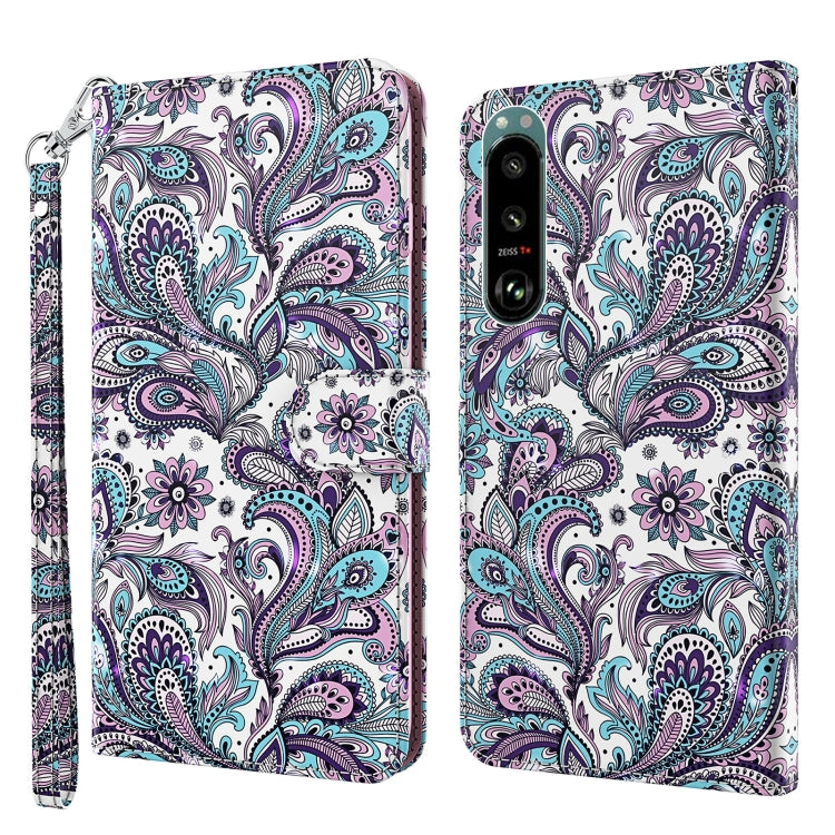 White phone case with purple and teal paisley floral pattern, wrist strap, back camera area