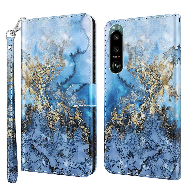 Phone case with blue and gold marbled pattern, leather-look finish, wrist strap, dual camera cutout