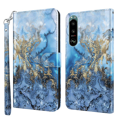 Phone case with blue and gold marbled pattern, leather-look finish, wrist strap, dual camera cutout