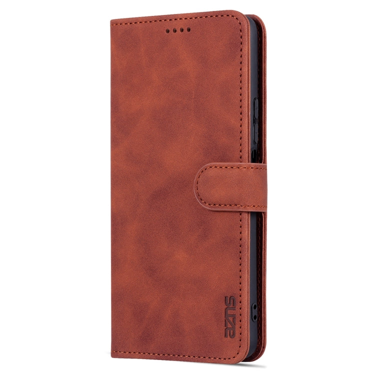 Brown flip leather phone case close-up with top speaker cutout and side strap