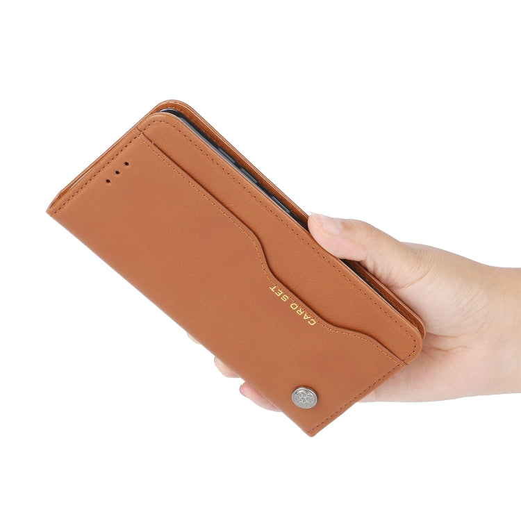 Brown leather wallet-style flip phone case held in a hand