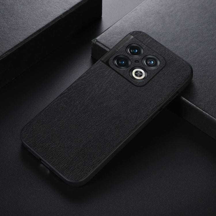 Black wood-texture PU phone case with camera cutout and raised lens rings.