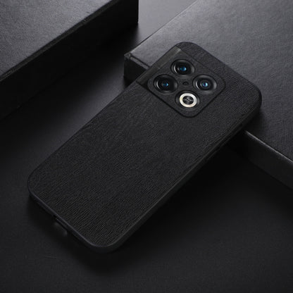 Black wood-texture PU phone case with camera cutout and raised lens rings.