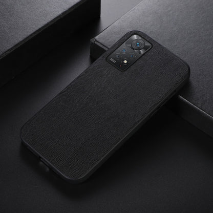 Black wood-grain PU phone case shown at an angle, with camera lens cutout