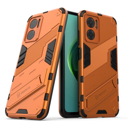 Orange rugged shockproof phone case with textured armor panels and holder