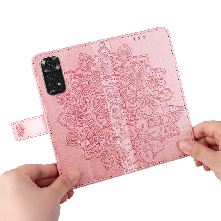 Rose gold leather wallet phone case with embossed 7-petal mandala floral design and hand holding