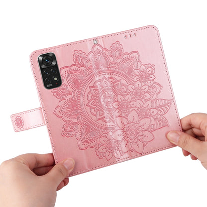 Rose gold leather wallet phone case with embossed 7-petal mandala floral design and hand holding