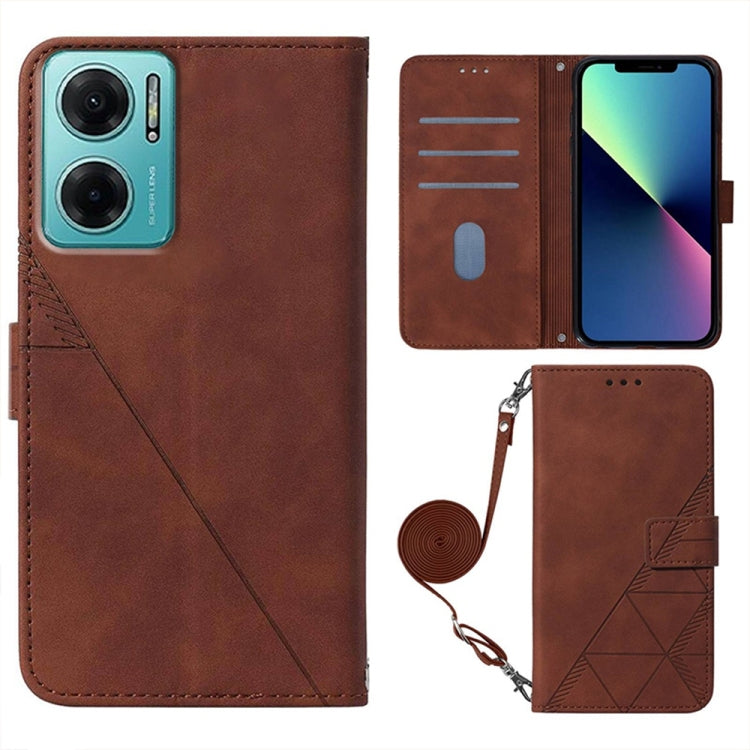 Brown leather-look flip phone case with embossed pattern, wrist strap, and card slots.