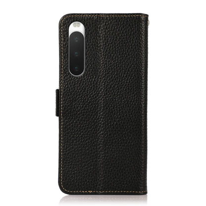 Black genuine leather flip phone case with camera cutout and side magnetic closure