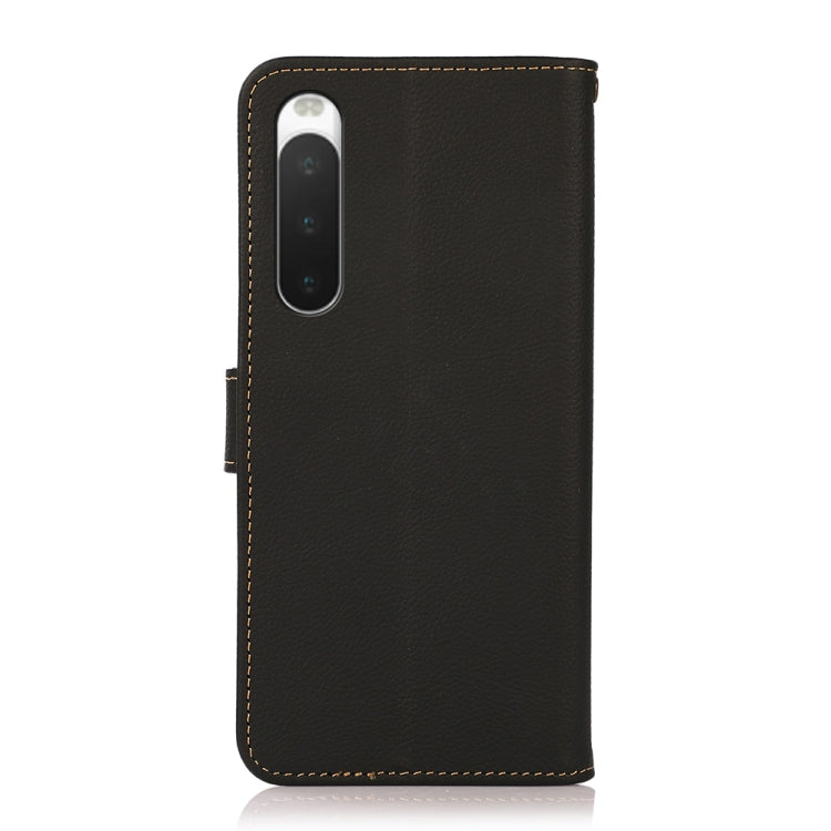 KHAZNEH genuine leather flip phone case, black, showing camera cutout and side strap