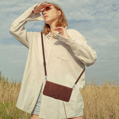 Brown embossed crossbody flip phone case worn across chest by a model outdoors