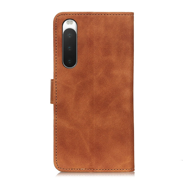 Brown leather flip phone case with camera cutout and stitched edge