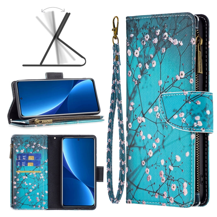 Teal leather phone case with zip closure, floral branch pattern, and interior card slots.