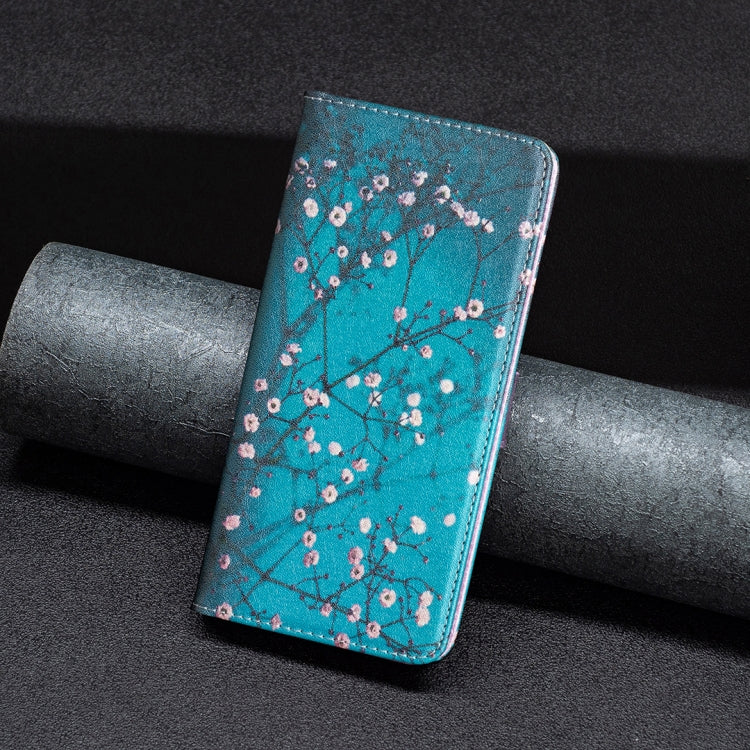 Turquoise magnetic leather phone case with plum blossom pattern on a dark couch.