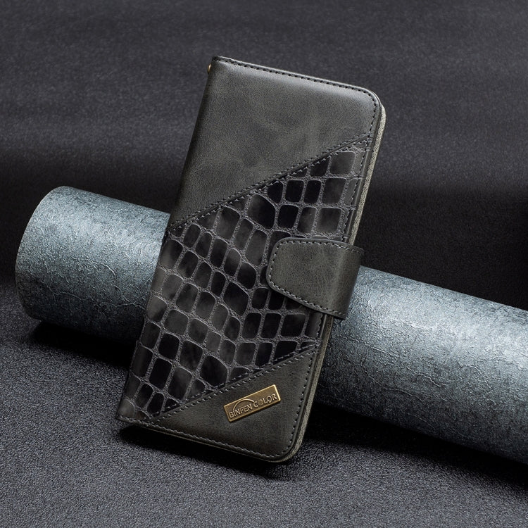 Dark crocodile-texture leather phone case with fold-over cover and gold badge detail