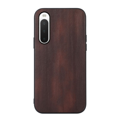 Brown textured PU phone case with camera cutout and protective raised edges.
