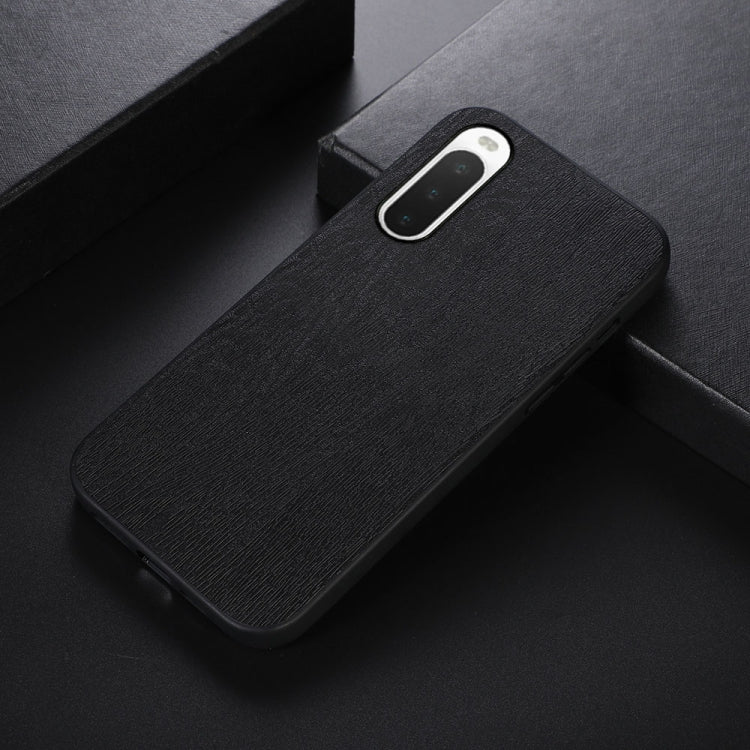 Wood-texture PU phone case with camera cutout, black, slim side angle