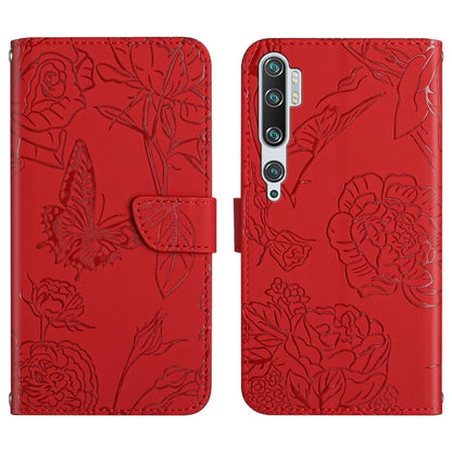 Red embossed leather folio phone case with butterfly peony floral pattern and flip strap.