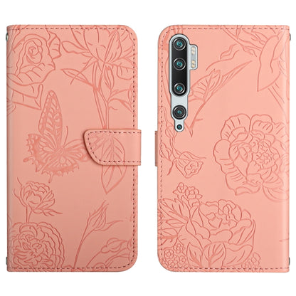 Pink embossed leather folio phone case with butterfly peony floral pattern and flip strap.