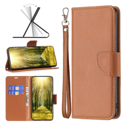 Tan/brown leather wallet phone case with flip cover, wrist strap, and card slot pocket.