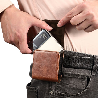 Brown leather waist phone case on belt with hands inserting a smartphone
