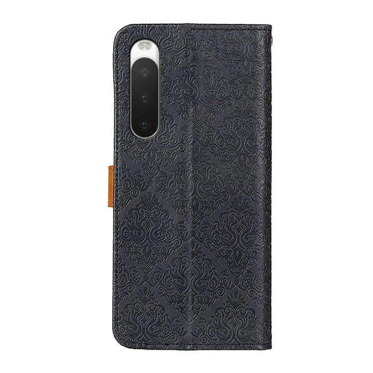 Embossed leather phone case with floral pattern, black, back cutout for camera and flash