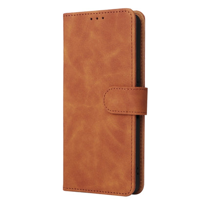 Brown leather flip phone case with stitched flap and magnetic closure strap.
