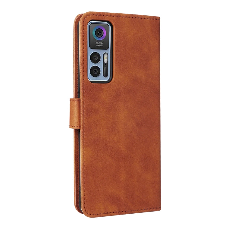 Brown leather magnetic flip phone case showing camera cutout and side stitching.
