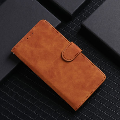 Brown leather magnetic flip phone case with snap strap and stitched front panel.