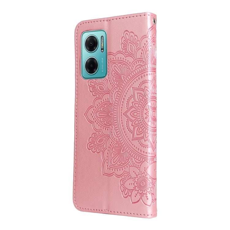 Rose pink leather wallet phone case with embossed seven-petal floral pattern and camera cutouts