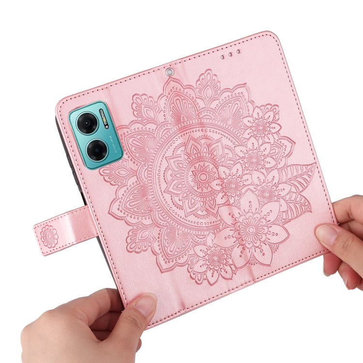 Rose pink leather wallet phone case with embossed seven-petal floral pattern, held by hands