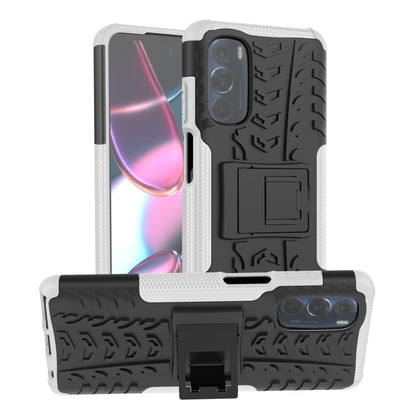 Tire-texture phone case with holder, white and black, showing rear camera and stand area.