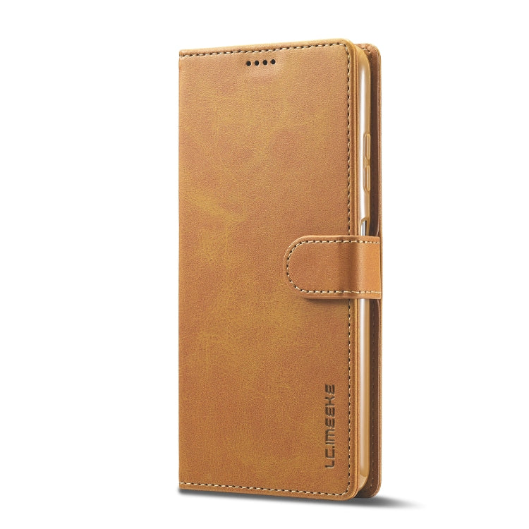 Brown leather phone wallet case with magnetic strap closure and stitched edges.