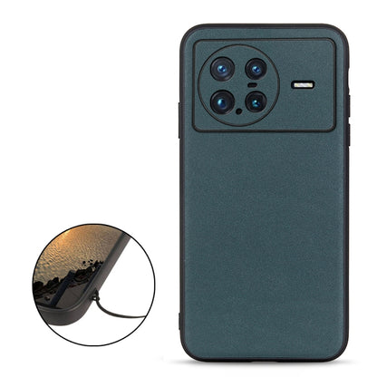 Dark teal-green genuine leather phone case with quad camera cutout and side ports