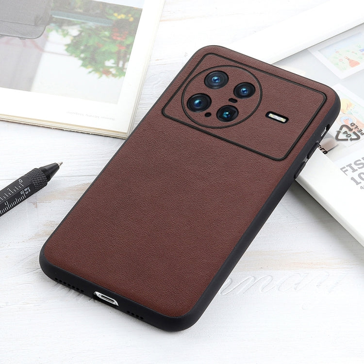 Brown genuine leather phone case, angled view with camera cutout and side openings