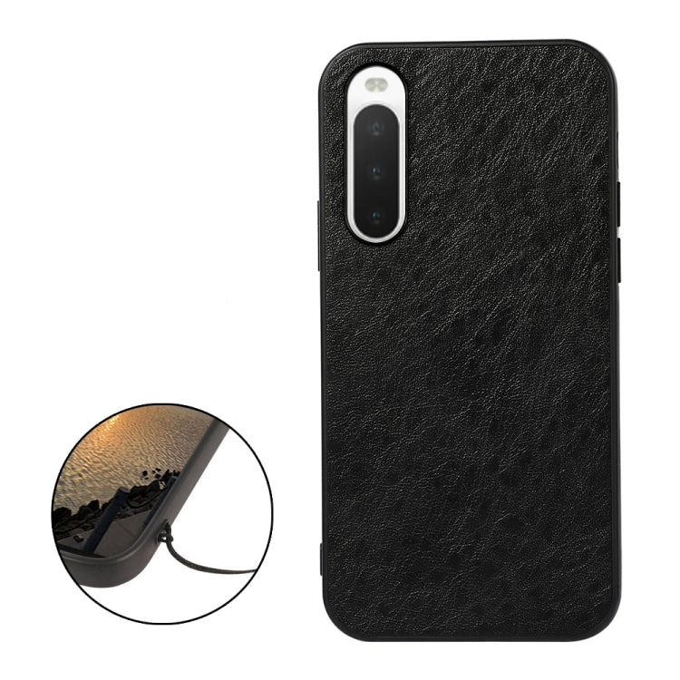Black textured leather phone case with camera cutout; close-up inset shows fine grain
