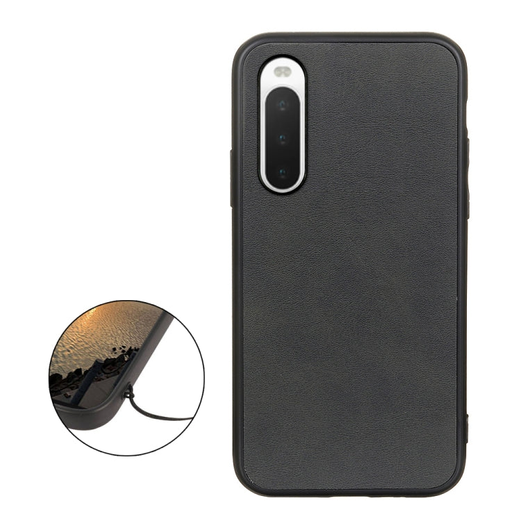 Black cowhide-texture PU shockproof phone case with protective raised edges.