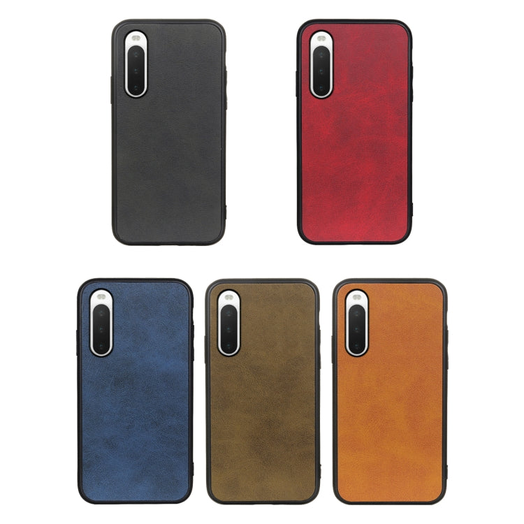 Phone case assortment in black, red, blue, brown, and orange with cowhide texture.