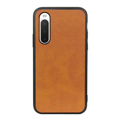 Orange cowhide-texture PU shockproof phone case with camera opening and port cutouts.